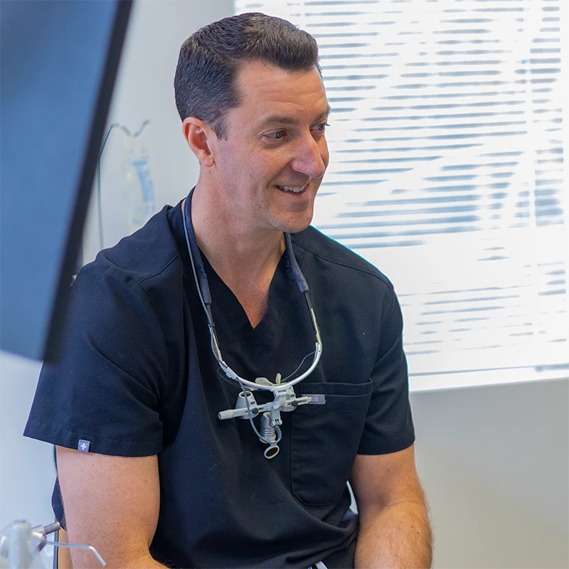 Raleigh Dentist - Dr. Lee Allen, DDS Smiling At Patient