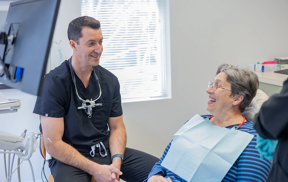 Dr. Lee Allen Talking With A Patient About Dental Implants