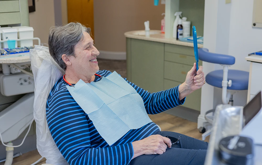 Real Patient Admiring Her Dental Crowns