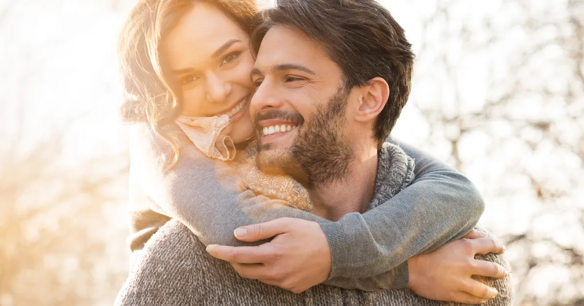 Girl Hugging Boyfriend With Perfect Teeth