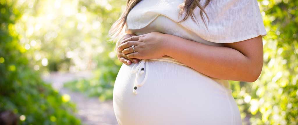 pregnant woman hands on belly